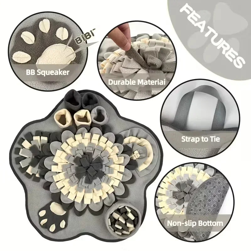 Grey and cream paw-shaped dog snuffle mat with squeaker, durable material, non-slip bottom, and tie strap.