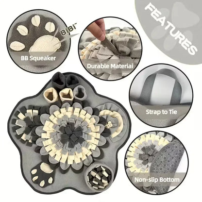 Grey and cream paw-shaped dog snuffle mat with squeaker, durable material, non-slip bottom, and tie strap.