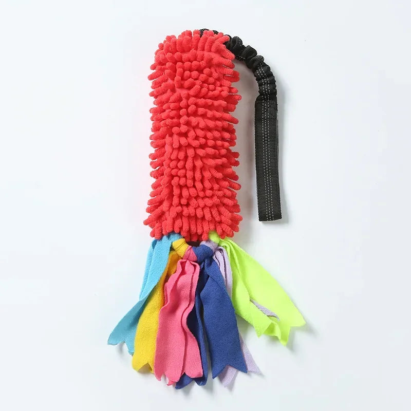 Plush red dog tug toy with black handle and colorful fleece tassels for interactive play