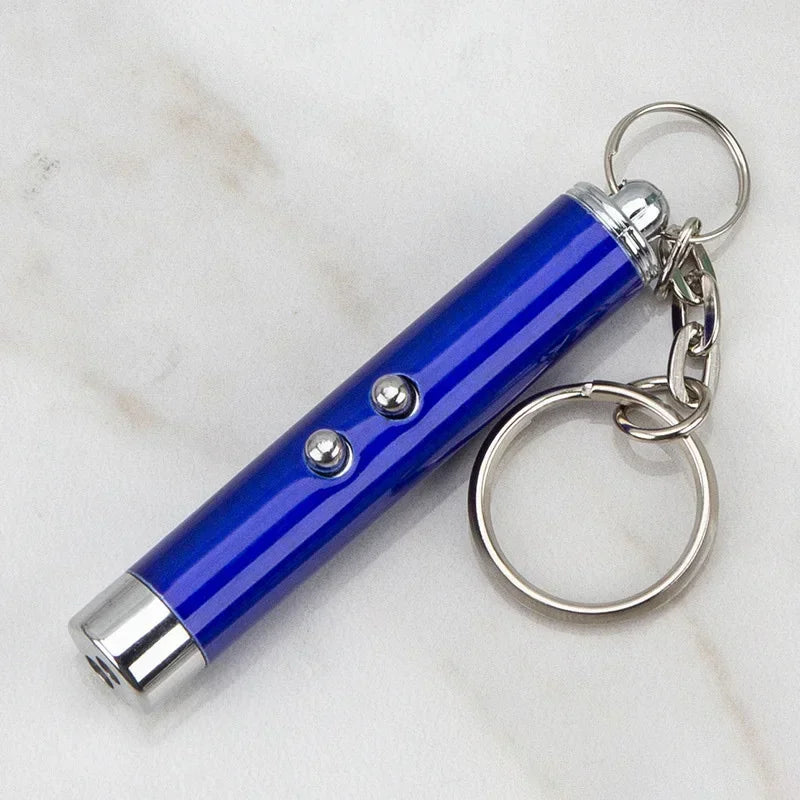 Blue laser pointer cat toy keychain for pet play on marble background