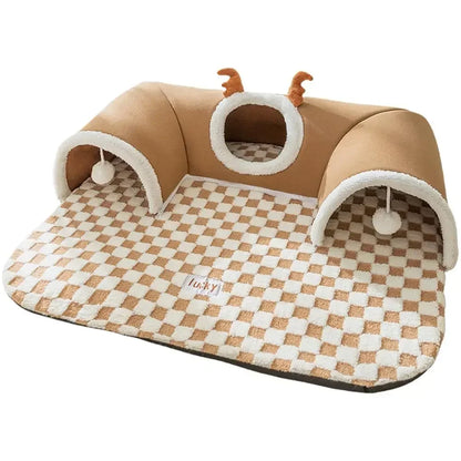 Plush cat tunnel bed with checkered mat, arch tunnels, hanging toys, and antler detail.