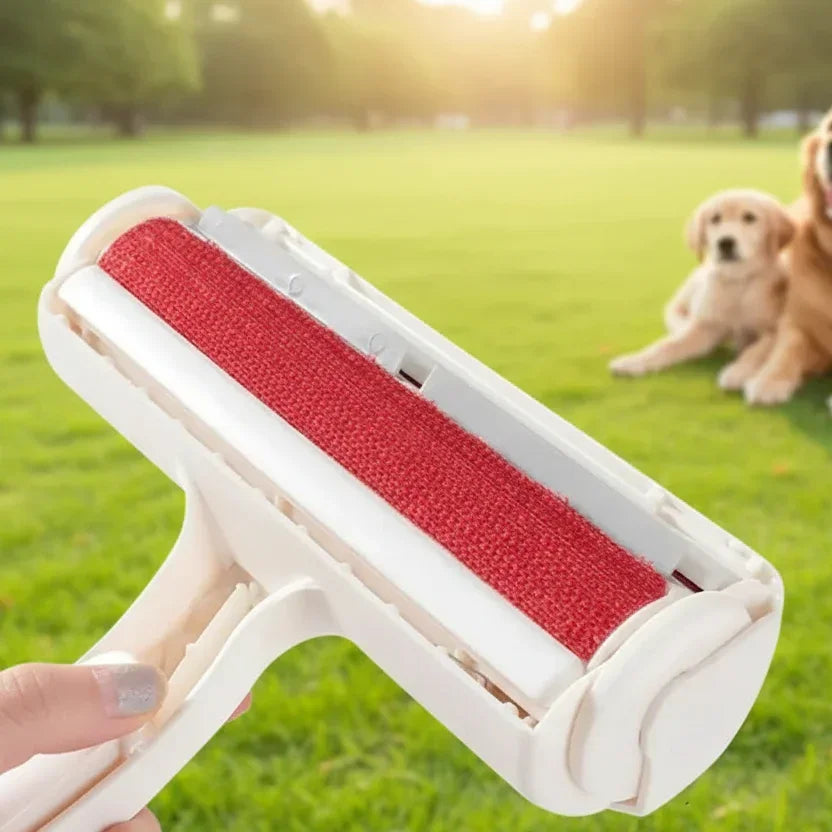 Handheld pet hair remover roller on grass with dogs in the background