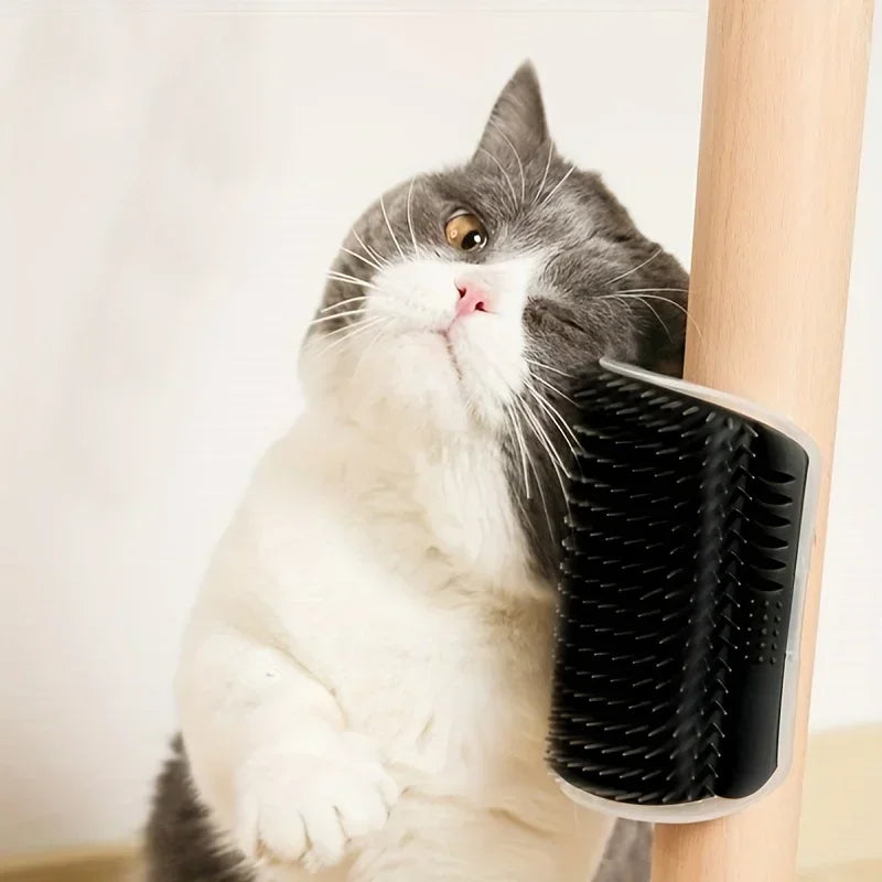 Gray and white cat rubbing face on black self-grooming cat brush attached to wooden post