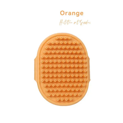 Orange silicone pet grooming brush with textured bristles for dog and cat care