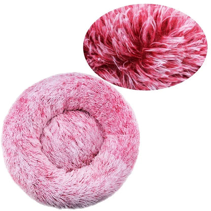 Plush pink round pet bed with soft faux fur texture for dogs or cats