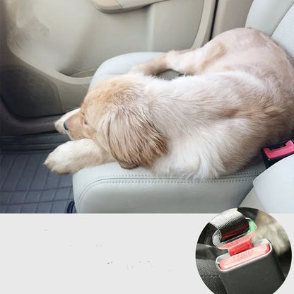 Golden retriever puppy lying on a car seat with a pet seatbelt clip shown in detail.