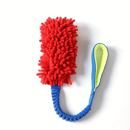 Red plush dog tug toy with blue rope handle on white background, durable pet play accessory