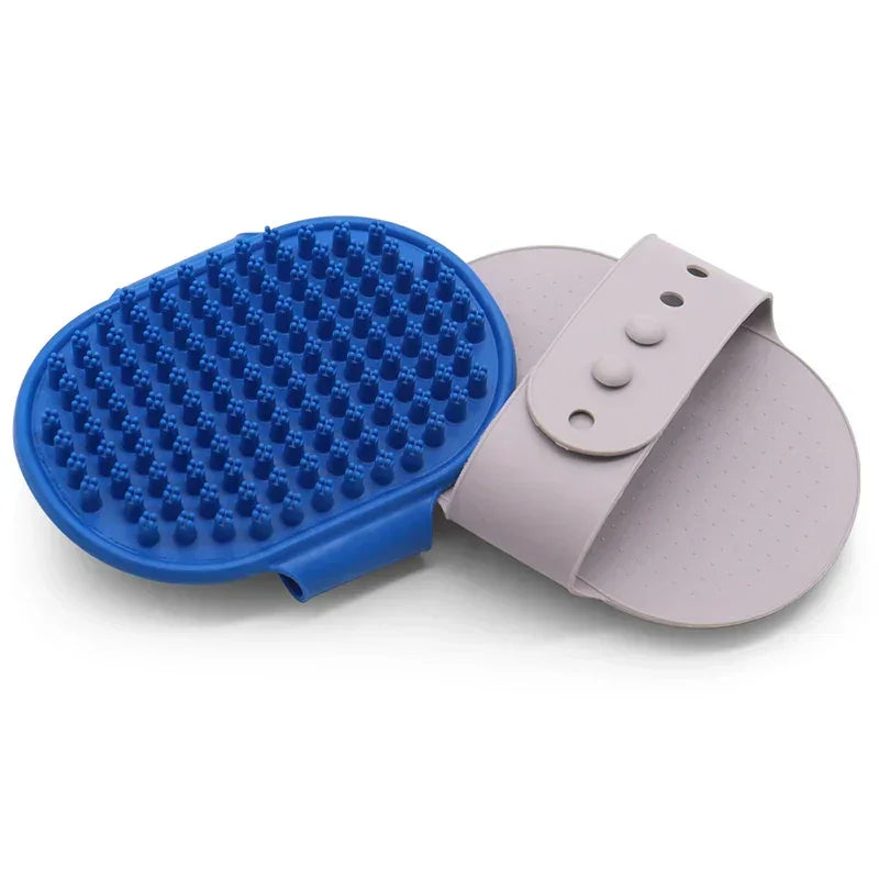 Blue silicone pet grooming brush with adjustable hand strap, ideal for dogs and cats.