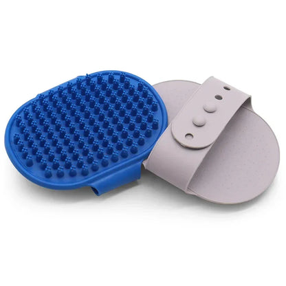 Blue silicone pet grooming brush with adjustable hand strap, ideal for dogs and cats.