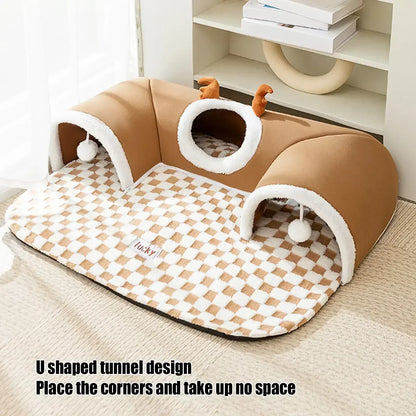Soft U-shaped tunnel cat bed with checkered pattern, plush antler details, and play balls for pets.