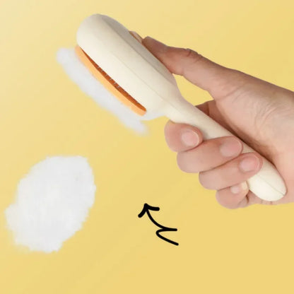 Hand holding a pet grooming brush with removed fur on yellow background