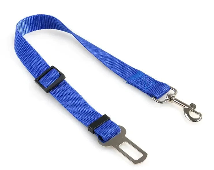 Blue adjustable dog seat belt with metal clip and car buckle attachment on white background